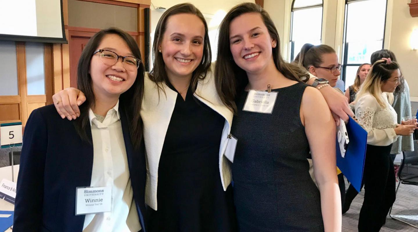 Three alumnae connecting at the EConnect dinner in 2024