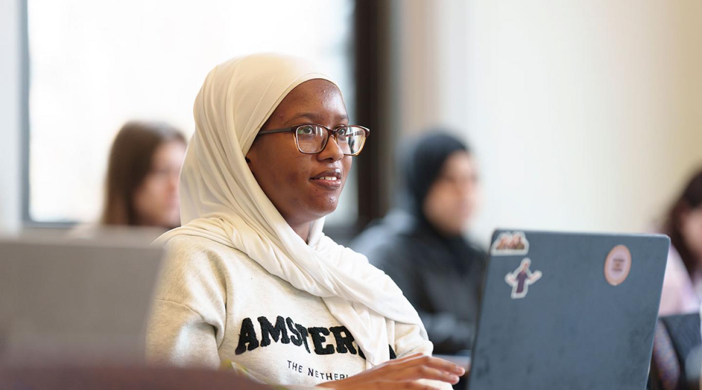 A student paying attention in a class at Simmons University