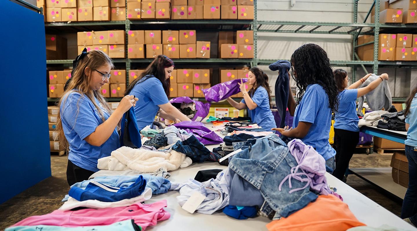Bonner Community Leaders sort clothes for Cradles to Crayons. Photo by Ashley Purvis