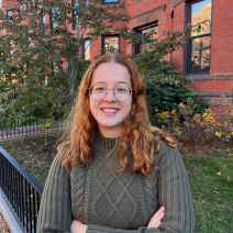 Katarina Sousa ’24 standing in front of a building on the Simmons University campus