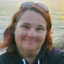 Karen Boss ’95 ’13MA riding on a boat