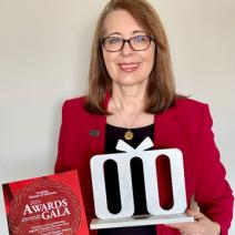 Sanda Erdelez with her award, which is in the shape of the first letter of the Croatian word for "woman” (žena). It is written in old Glagolitic script, the oldest known Slavic alphabet.