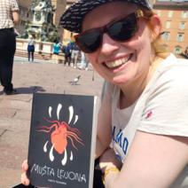 Pirita Tolvanen holding her book “Manifesto on Illustrating Data” 