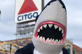 Stormy the Shark in front of the CITGO sign