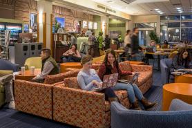 Students sitting in a common area in the Main College Building at Simmons University