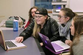 Students working together around laptops