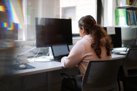 student at desk using laptop