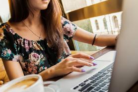 A student working on a laptop with a cup of coffee on their desk. Image by Pexels from Pixabay.