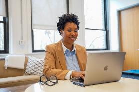 Student working on laptop in office space