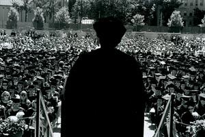 Back view of speaker in front of graduating students