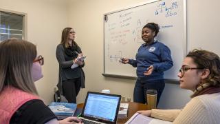 Four Simmons University graduate students in a classroom