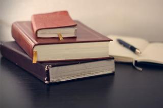 stack of books and an open notebook