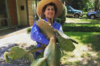 Cindy Fisher holding a giant cactus.