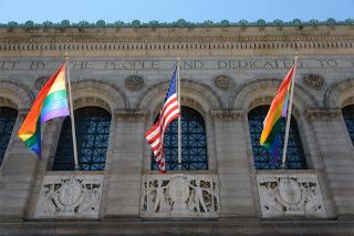 Pride flags and U.S.flag outside of Boston Public Library.