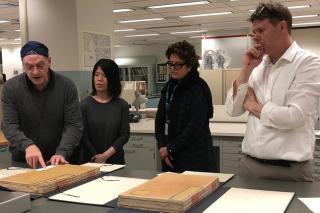 Conservators Alan Haley, Qui Qi, Ann Roddy, and Dan Patterson in the conservation department of the Library of Congress, working with the Yongle Da Dian.