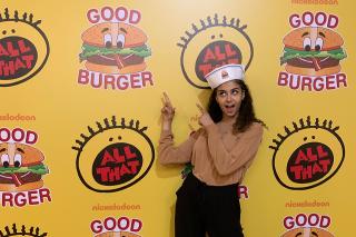 Yasmine Ebeed standing in front of a media wall 