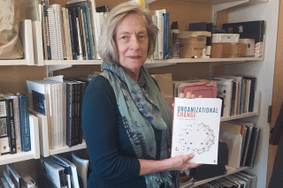 Professor Cynthia Ingols with her Organizational Change textbook