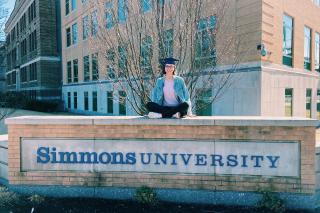 Lilli Thorne on the Simmons University sign