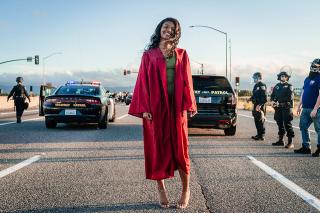 Jada Riley in her graduation gown attending a protest against police brutality.