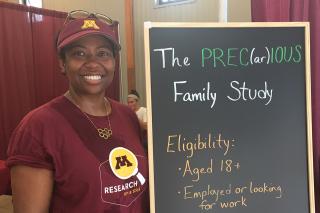 Renada Goldberg with a chalkboard about her Precious Family Study