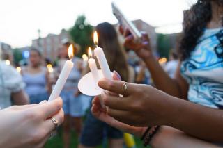 Students lighting candles at the candle lighting ceremony