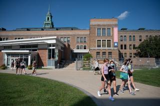 Students walking during orientation 2022 in main quad heading with MCB/Fens in background