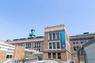 Main Campus Building under a bright blue sky