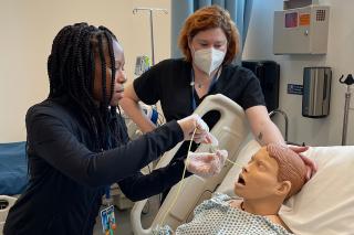 Students working on test patient mannequin