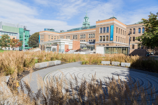 The Simmons University campus with the brick labyrinth in the foreground and the main campus building in the background