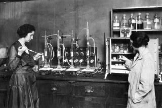 Two students in a science lab, circa 1920s.