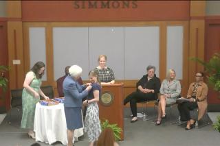 A graduating student in the Nursing program receives her Nursing pin
