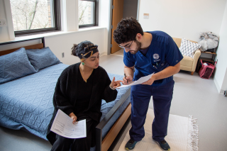 A nursing student working in a home health simulation room