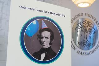 Founders Day poster with John Simmons in party hat and balloon