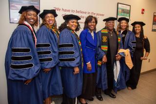 Doctoral Graduates lined up with President Wooten and others 