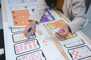 A student working on a phone app by drawing out the components