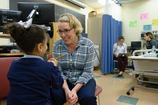Nursing student working with child