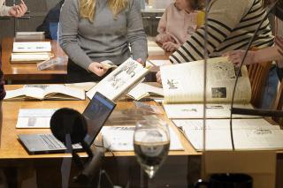 Students working with archives on a table