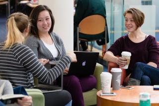 Students enjoying coffee and conversation sitting at the Fens