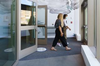 People walking through doorway of Simmons Building