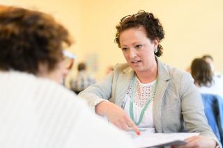 Two adult Simmons students having a conversation during a class