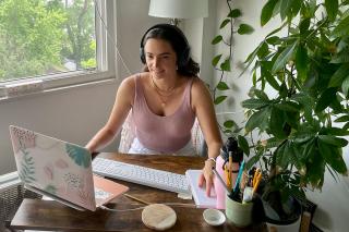 A student engaging with Simmons University online