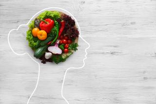 A graphic of the outline of a person with vegetables inside the head