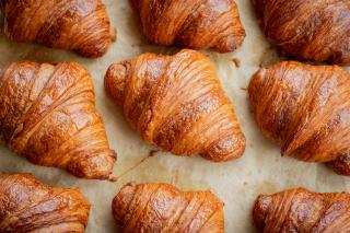 Croissants on a bakery tray. Photograph by Conor Brown, courtesy of Unsplash.