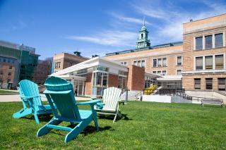 Simmons Campus in the spring. Chairs on grass in quad.