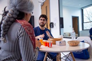 A Simmons nursing student working with "Carlotta" in the home health lab