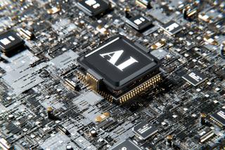 A close-up photo of a microchip where one of the components is labeled AI. Photo courtesy of Unsplash.