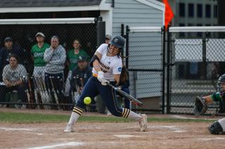 A Simmons softball player taking a swing