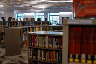 A large room with low bookshelves in the Simmons University library.