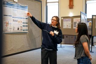A student discussing her research at the 2026 STEM Student Colloquium