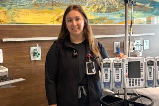 Haley Dover ’22 standing among equipment in a hospital room